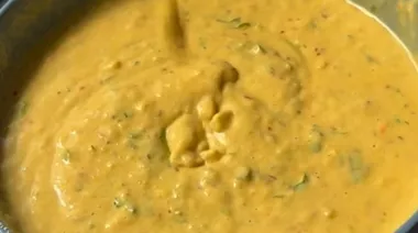Liquid aloo paratha being cooked on tawa with golden crisp edges 3